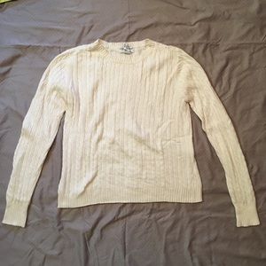 Cream-colored cable-knit sweater
